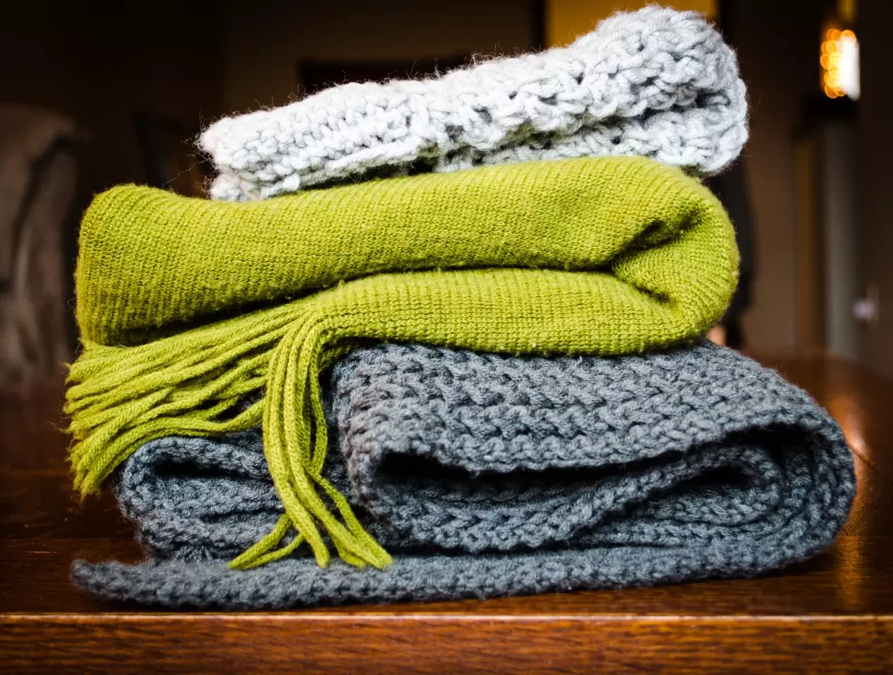 a stack of folded blankets/scarves