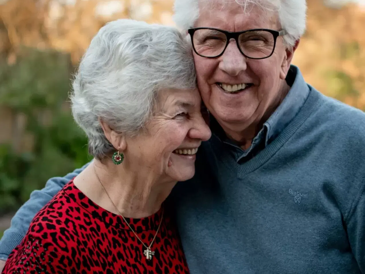 Older man and woman hugging