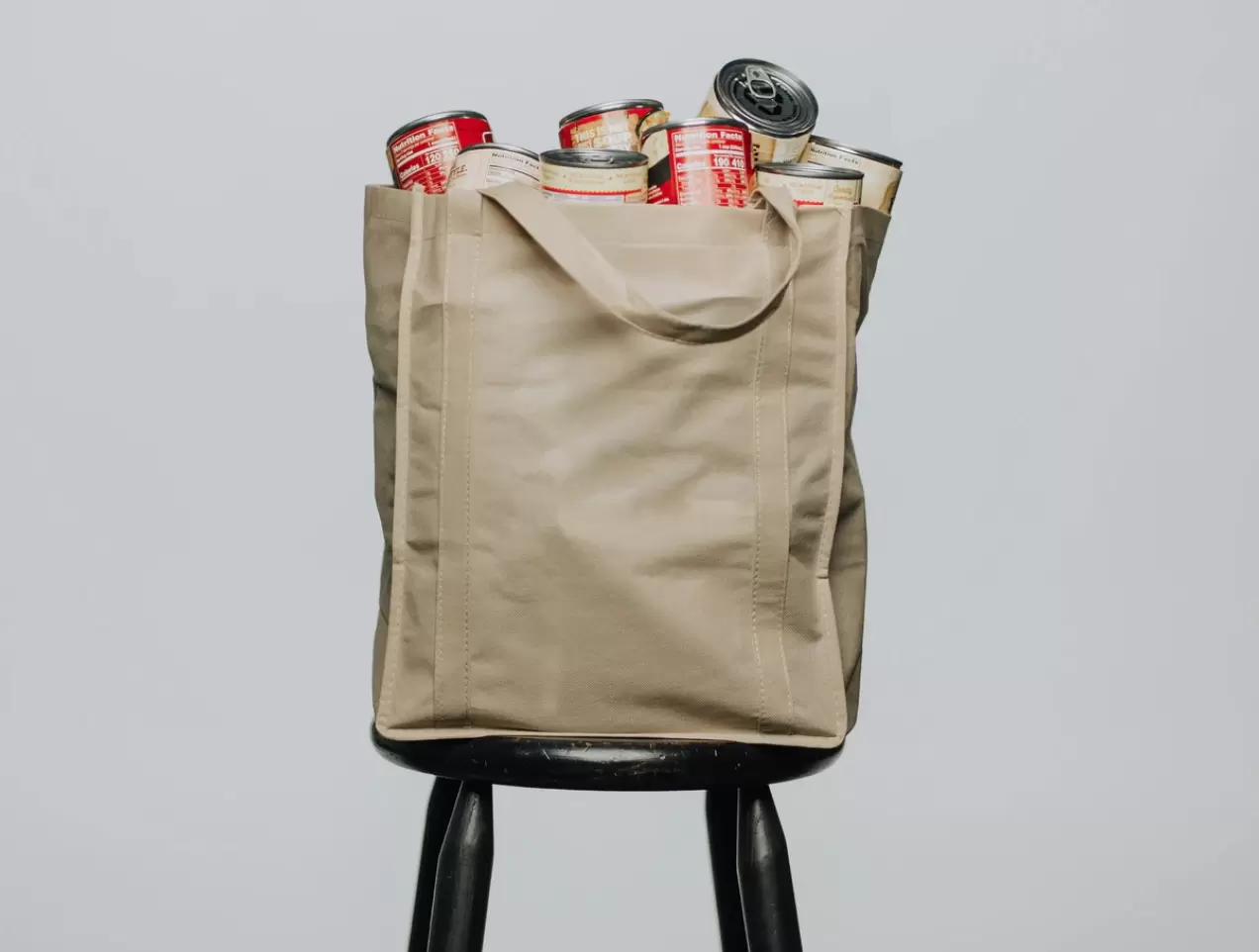 reusable grocery bag full of canned goods