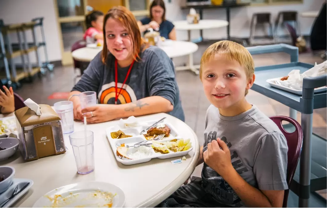 Boy eating lunch in a cafeteria setting