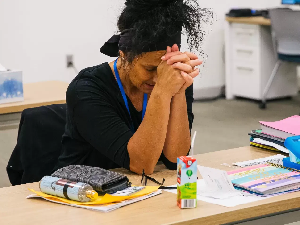 Woman praying at a desk