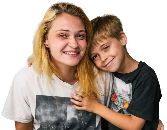 Boy resting his head on the shoulder of his mom