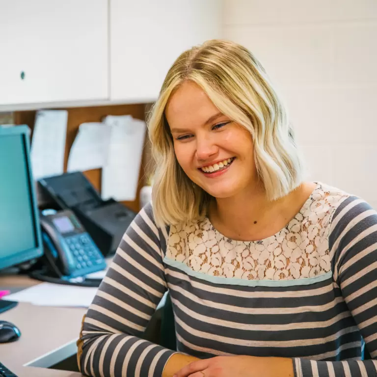 Office staff smiling and being helpful